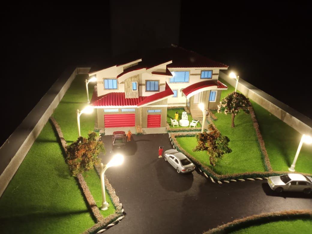 A handmade architectural model photographed at night — model making at Lizben