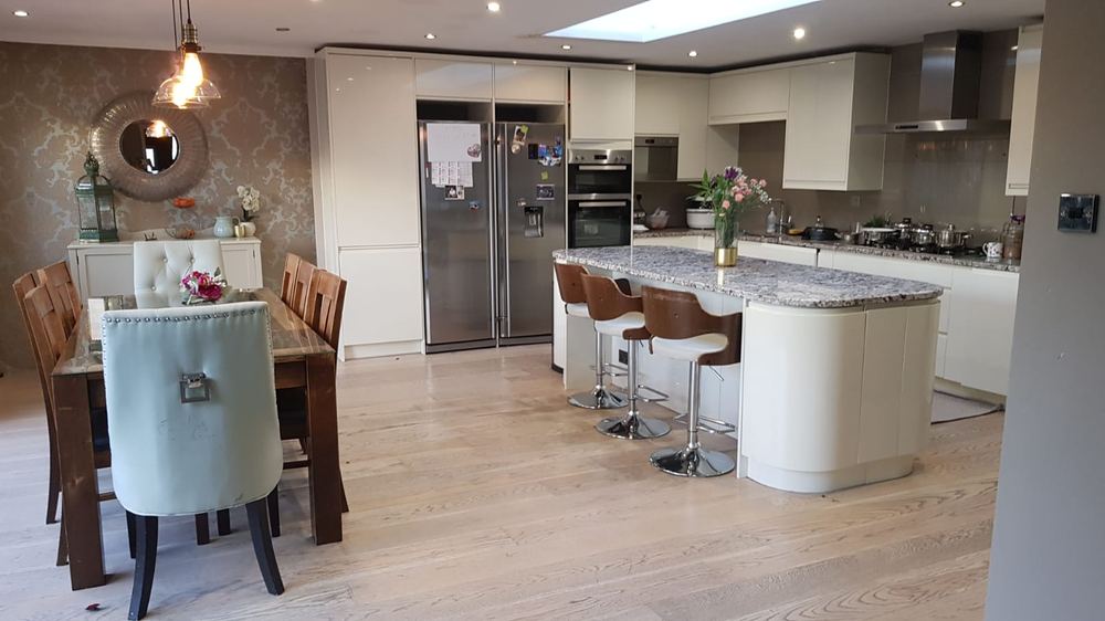 Remodelled kitchen and dining space with island, pendant lighting and roof glazing
